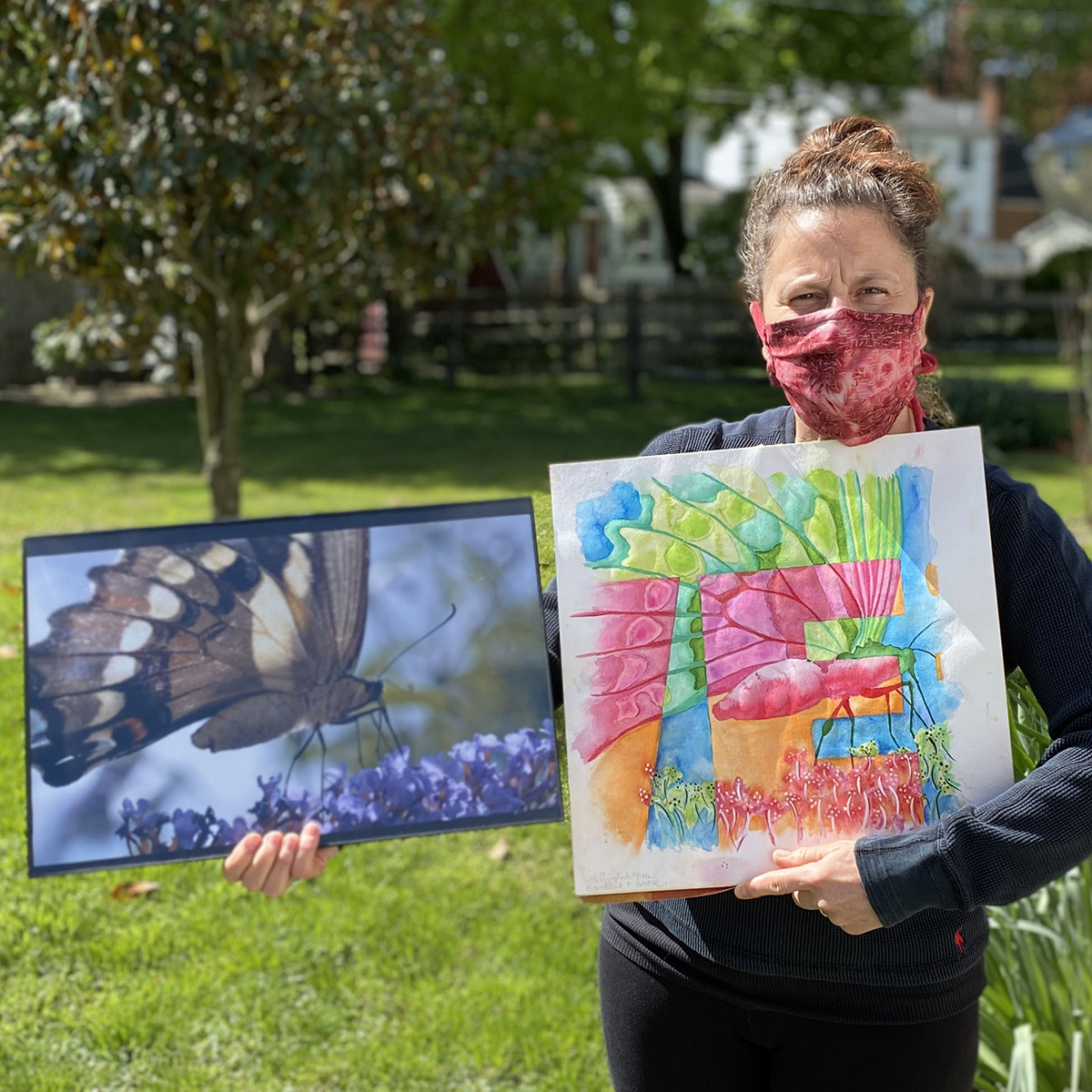 Leslie holding artwork together with Mark's photograph